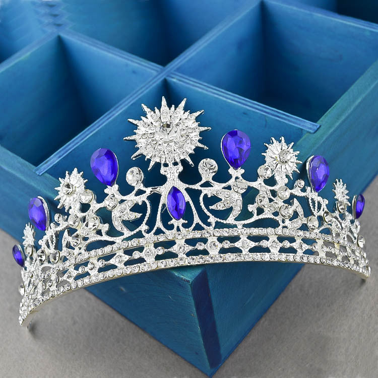 Royal Crown Headwear and Accessories featuring a sparkling tiara with purple stones and crystal rhinestones.
