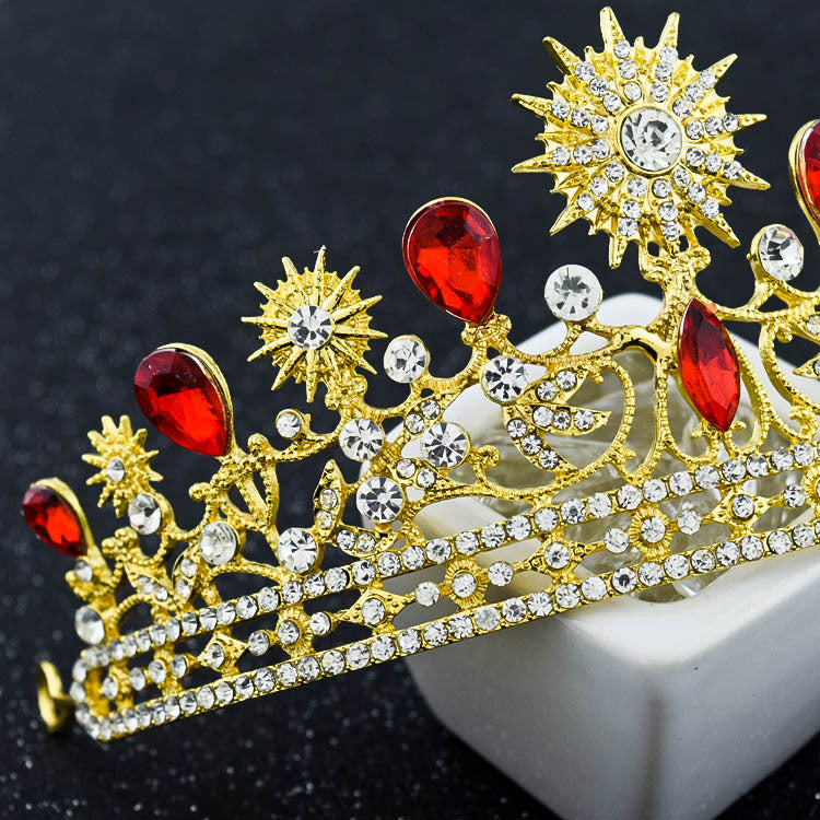 Royal Crown Headwear and Accessories with sparkling rhinestones and red crystals on a display.